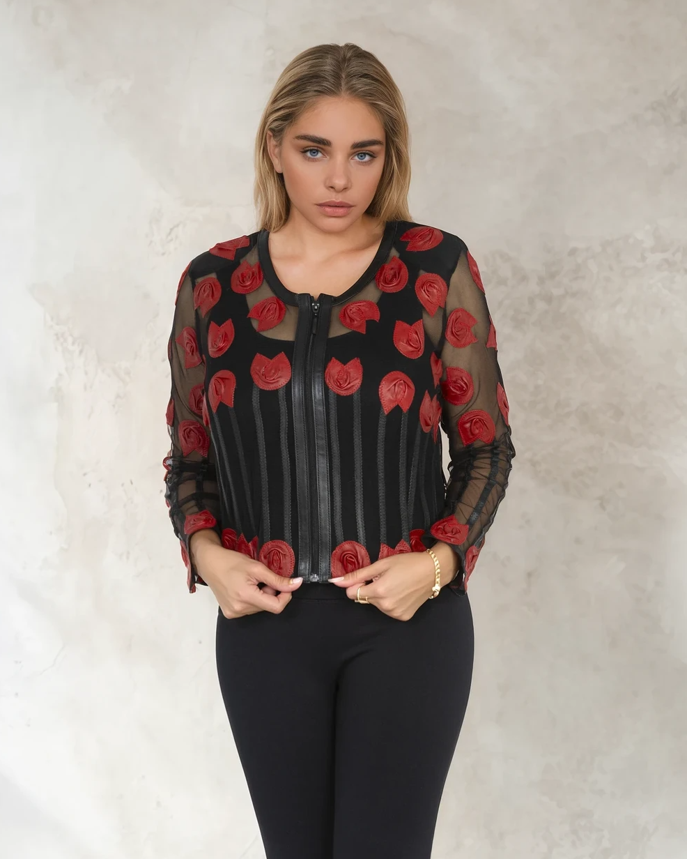 Woman wearing a black outfit with red rose patterns on a neutral background