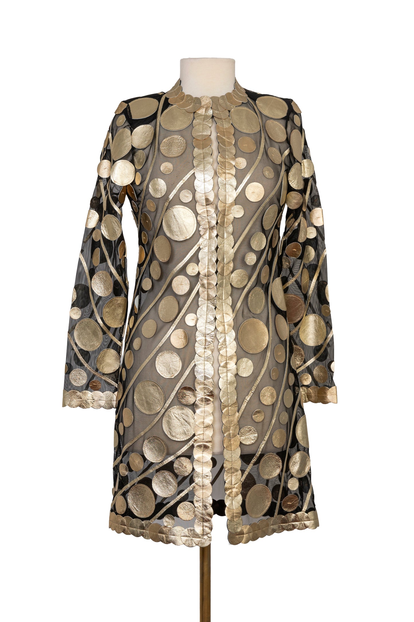 Elegant black sheer long-sleeve jacket featuring shimmering gold metallic circular appliqué details, an open-front design with decorative trim, and a lightweight statement silhouette, displayed on a mannequin.